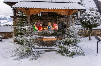 Thrilling Epic Christmas 2025 Murzasichle Tatra Adventures: Snowy wooden nativity scene with glowing Holy Family figures, frosted evergreens, and misty Tatra hills in Poland's festive winter glow Snowy wooden nativity scene with glowing Holy Family figure